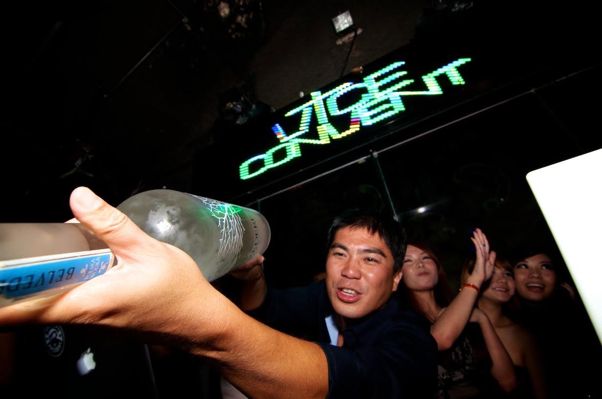 Uncle Bryan under the Vice Convent sign, Belvedere in hand, at Filter Members Club.